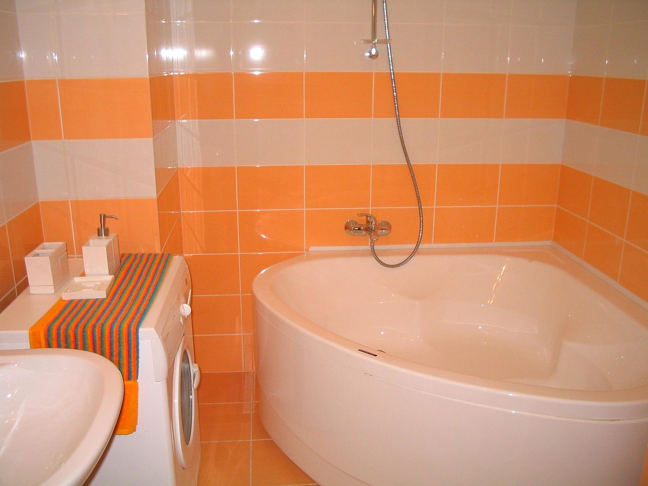 Alcove bathtub with a white tile surround and chrome fixtures